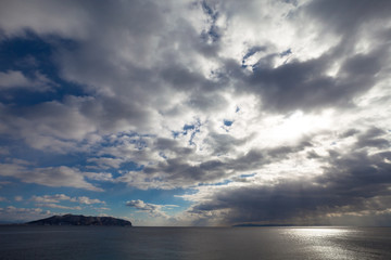 Fototapeta na wymiar 津軽海峡を覆う雲と函館山　/　北海道から望む津軽海峡と下北半島