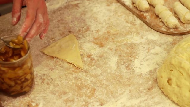 Woman working with dough. making homemade croissants