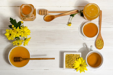 bee products  with cup of tea on wooden table