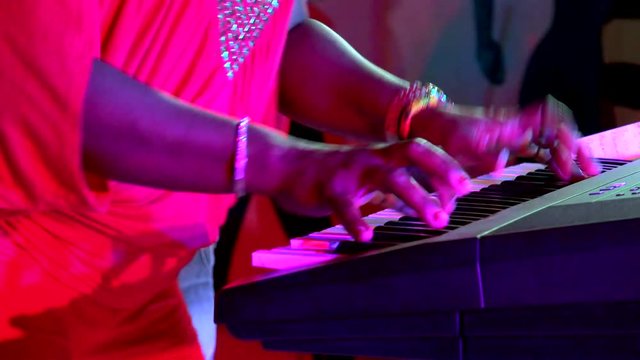 Sharp play on the electronic musical keyboard at nightclub