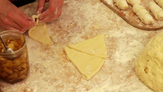 Woman working with dough. making homemade croissants