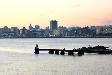 Naklejka premium Sunset scene of beach and skyline at background, Montevideo, Uruguay