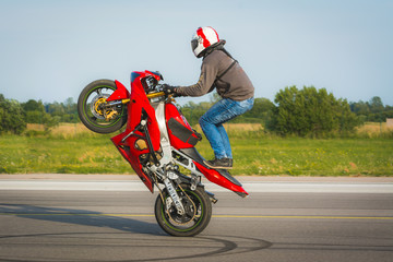 Red stunt bike standing wheelie