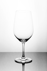 Crystal glass on a glass table, white background