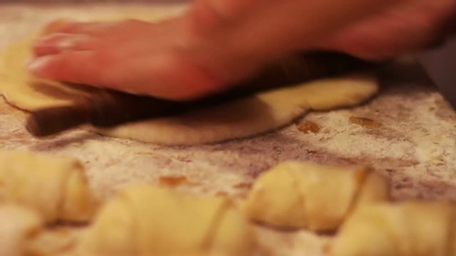Woman working with dough. making homemade croissants