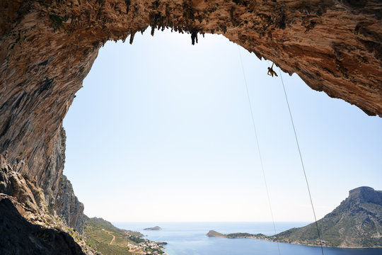 Greece, Kalymnos, climber abseiling in grotto
