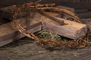 Crown of Thorns and Wooden Cross on a Weathered Wooden Surface