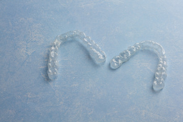 Clear Invisible Teeth Aligner on a blue background