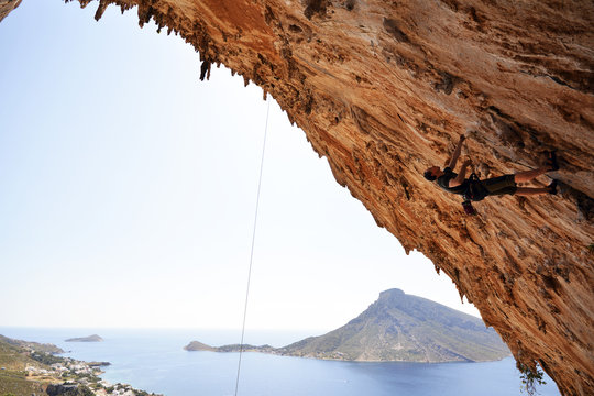 Greece, Kalymnos, climber in rock wall