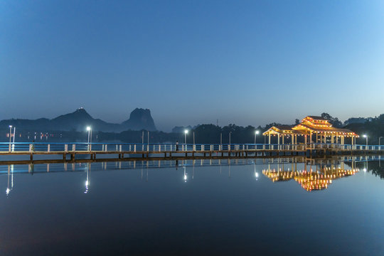 Myanmar, Hpa-an, Illuminated pier at Kan Thar Yar Lake at blue hour