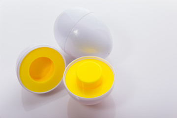 Plastic egg developmental puzzle yellow to form a circle on a white background.