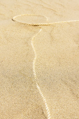 Rope on sand background