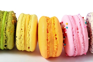 Colorful macarons with decorations in stack isolated. Top view