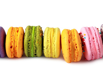 Colorful macarons with decorations in stack isolated. Top view