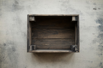 Empty crate of fruit on background of shabby gray marble. Top view, copy space