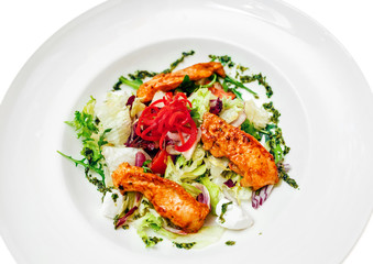 Fresh salad on a plate with fried chicken, feta cheese and herbs