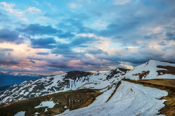 beautiful view of the mountains at sunset (sunrise) is partially covered with snow. Beautiful sky...