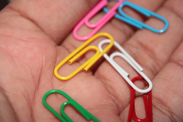 Colorful paperclips in hand

