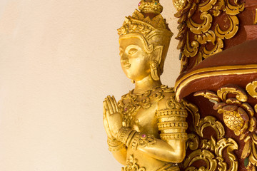 Golden stucco of the angle at the wall of Thai temple.