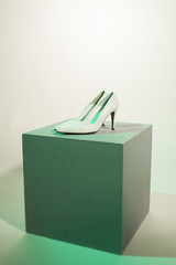 white high heel on a grey box
