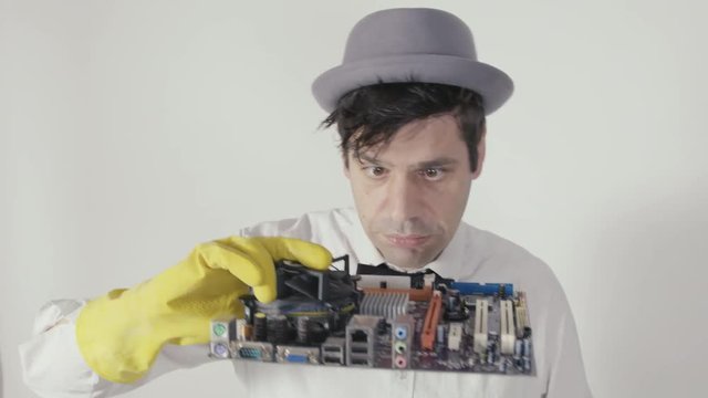 Computer Service A funny guy with hat brushing a mainboard. It looks a little like the mupped show. It can be used as the adverse advertising for computer stores and services for electronic system.