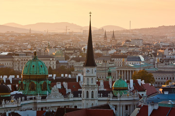 Tower of St. Michael's Church at sunset, rooftop view. Famous view of Vienna in the evening. Orange...