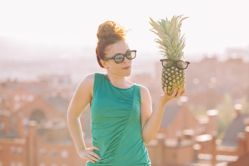 confused woman holding a pineapple with glasses.