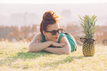 funny woman talking to a pineapple with glasses
