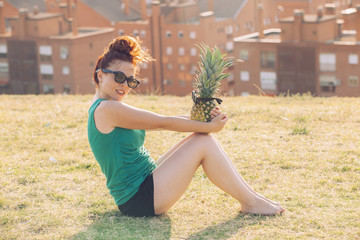 hipster woman holding a funny pineapple with glasses