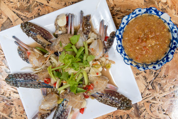 thai style raw spicy blue swimmer crab salad served with seafood sauce