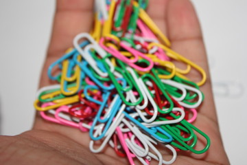 Colorful paperclips in hand

