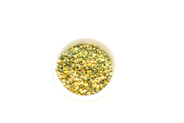 Bowl of yellow and green peas isolated on white background, top view