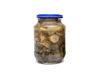 marinated wild mushrooms in a jar on a white background