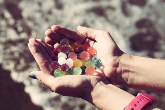 Colorful balls in hands orbeez