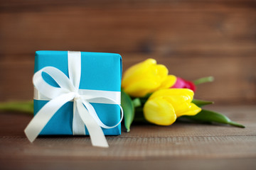 Blue gift with tulips. Conception holiday, March 8, birthday, Mother's Day.