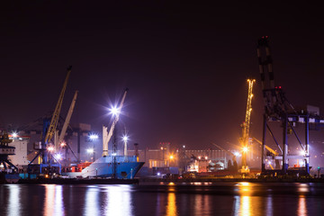 Fototapeta na wymiar Panorama image of the illuminated cargo port in Novorossiysk, Russia