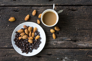 Coffee cup espresso tree in one and coffee beans background on a wooden table , top view