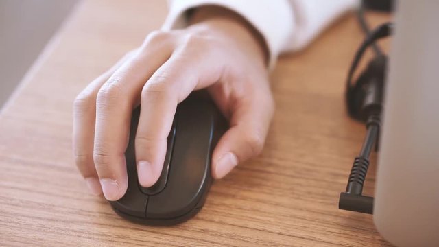 Hand using computer wireless mouse in film tone style
