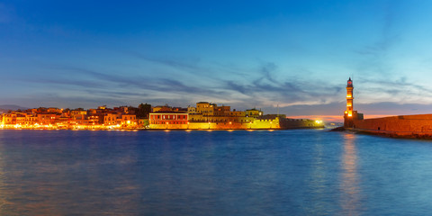Fototapeta na wymiar Panorama venetian harbour waterfront and Lighthouse in old harbour of Chania during twilight blue hour, Crete, Greece