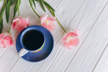 pink tulips and coffee cups. Mother's Day or Women's Day on a white background