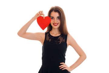 young happy brunette lady with red heart in hands smiling on camera isolated on white background. Valentines Day concept.