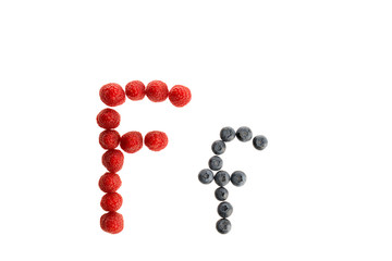 Alphabet from fresh fruit, raspberry and blackberry