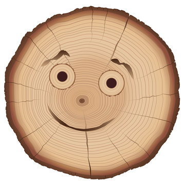 Tree slice with smiling comic face and many annual rings.