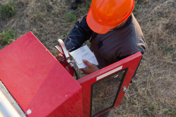 Naklejka premium Safety officials checking a fire extinguisher