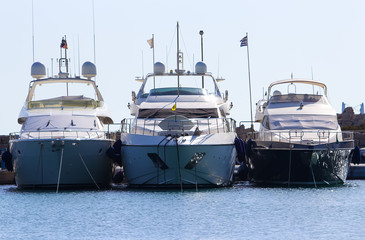 Fototapeta na wymiar three yachts on docks of port Mandraki Rhodes Greece