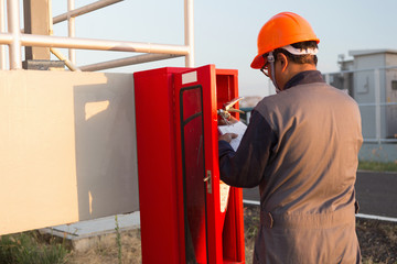 Obraz premium Safety officials checking a fire extinguisher