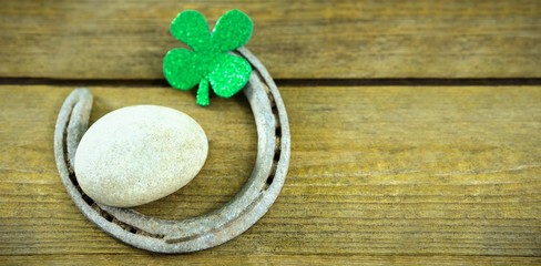 St Patricks Day shamrocks with horseshoe and pebble