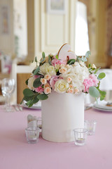 Wedding guest table decorated with bouquet and candlesticks