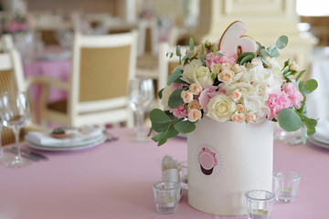 Wedding guest table decorated with bouquet and candlesticks