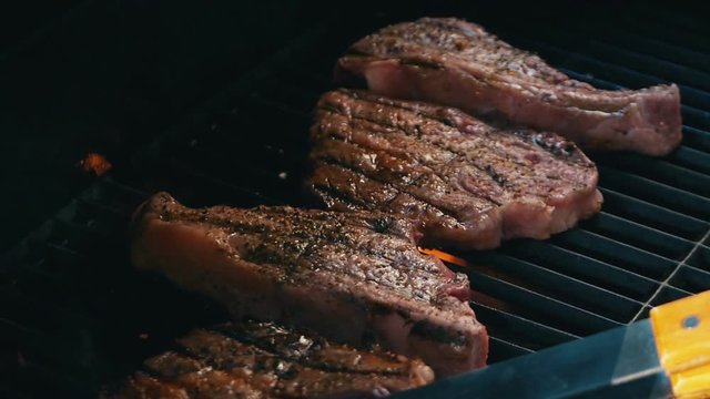 High quality video of steaks on barbecue grill in slow motion